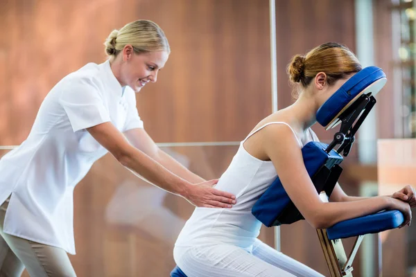 Woman receiving massage in massage chair