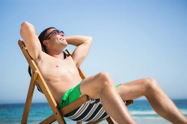Man sitting and relaxing on deck chair