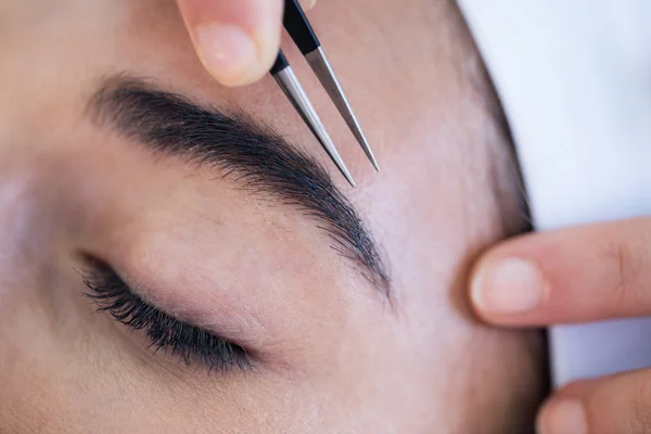 Woman getting eyebrows shaped