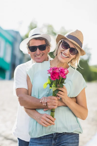 Happy couple holding roses