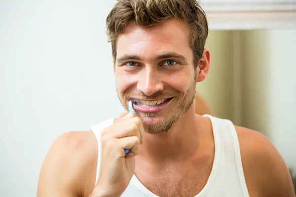 Young man brushing teeth