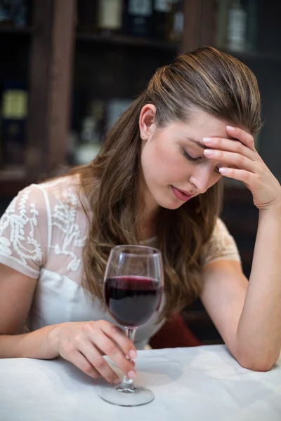 Depressed woman with wine glass