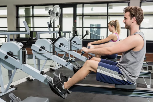 Man and woman on rowing machine