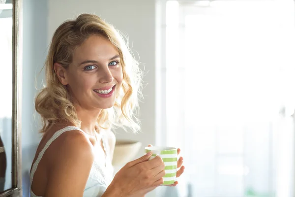 Woman having coffee at home