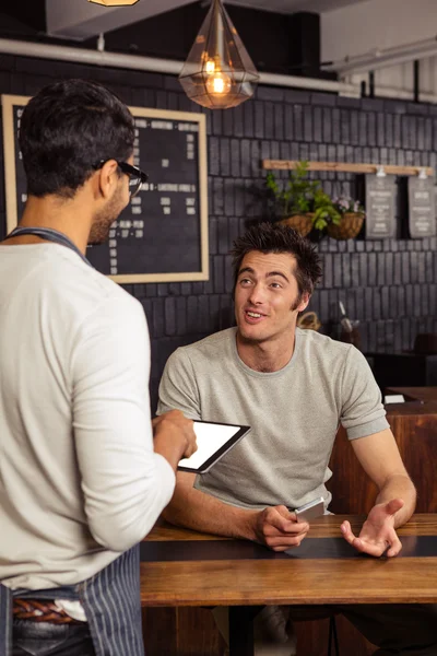 Waiter and customer talking