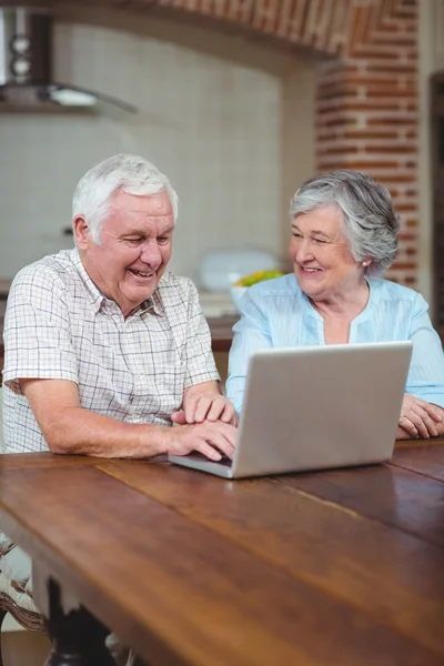 Couple typing on laptop