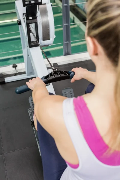 Woman exercising on rowing machine