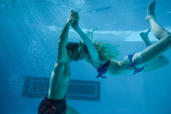 Cute couple kissing underwater