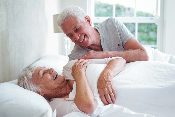 Senior couple relaxing on bed