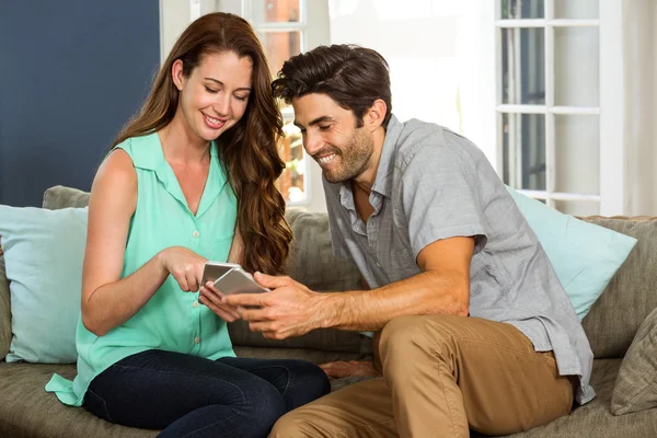 Couple looking at phone and smiling