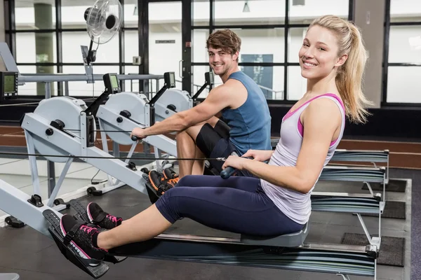 Man and woman on rowing machine