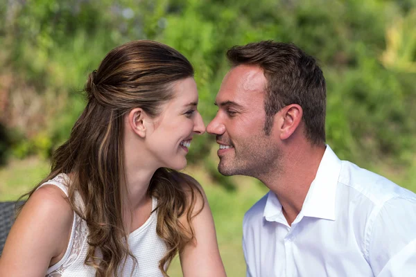 Couple face to face in park