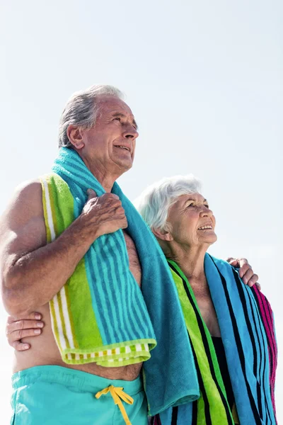Senior couple holding towel around neck
