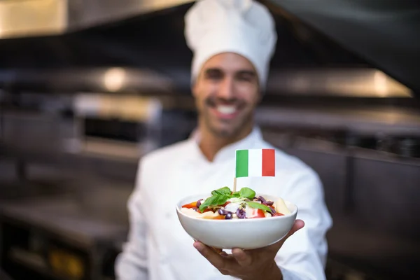 Chef presenting meal with italian flag