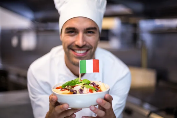 Chef presenting meal with italian flag