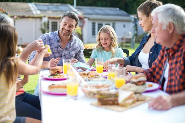 Multi-generation family eating at table