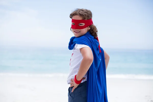 Boy in superhero costume standing