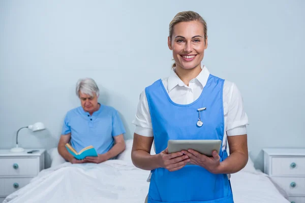 Nurse holding digital tablet at hospital