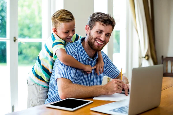 Father with son working by technologies