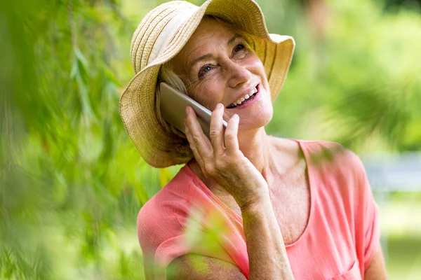 Woman using phone in yard