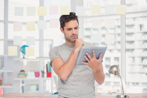 Man holding tablet and sticky notes
