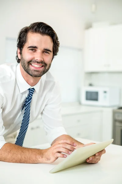 Businessman using digital tablet at table