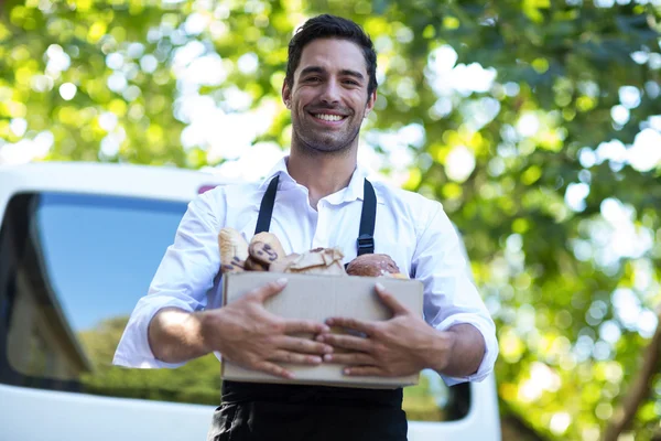 Delivery person carrying package