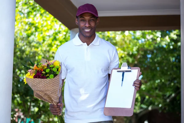 Delivery man holding flower bouquet