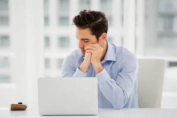 Tensed businessman with laptop