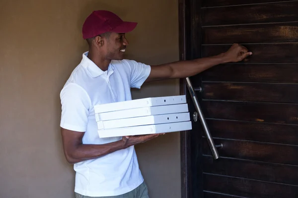 Pizza delivery man with pizzas boxes