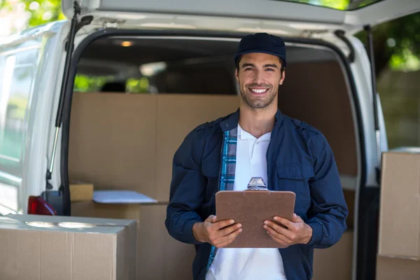 Delivery man holding clipboard