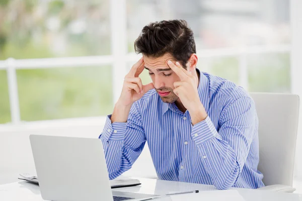 Frustrated businessman with hand on head