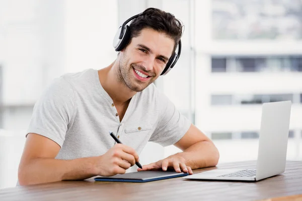 Man using pen tablet and laptop