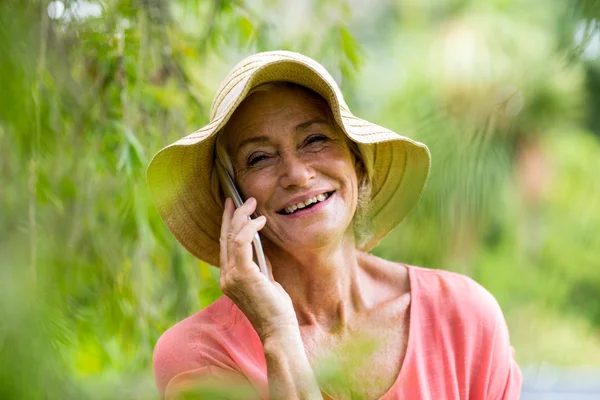 Woman talking on phone in yard
