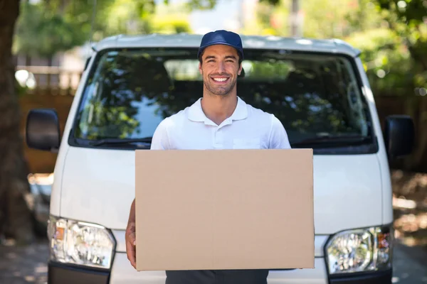 Delivery person holding cardboard box