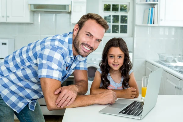 Father and daughter with laptop