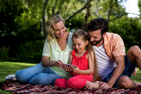 Parents with daughter looking at mobile phone