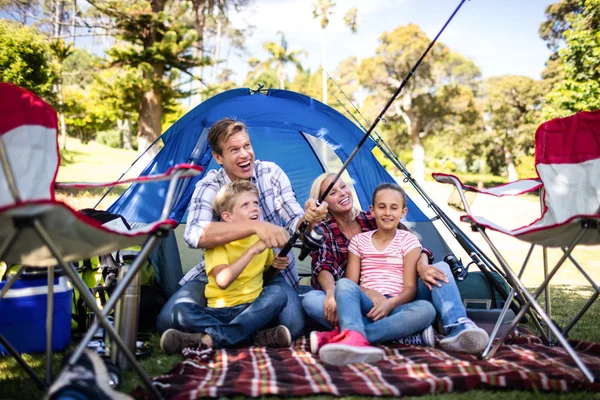 Family fishing outside tent