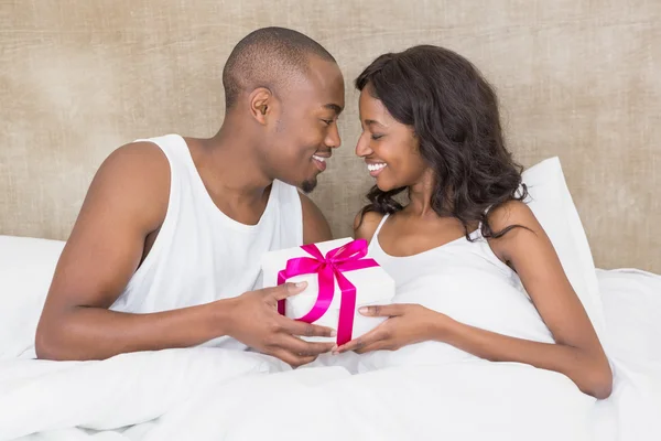 Man presenting gift to woman