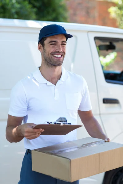 Delivery man with clipboard and cardboard box