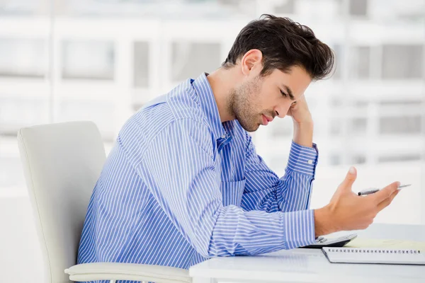 Worried businessman calculating accounts