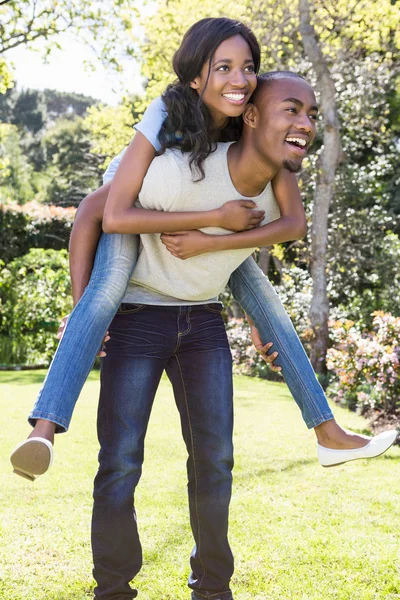 Man giving piggyback ride to woman