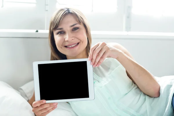 Woman showing digital tablet
