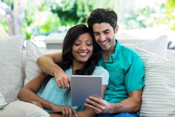 Couple on sofa using tablet