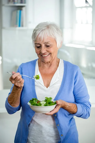 Senior woman eating salad