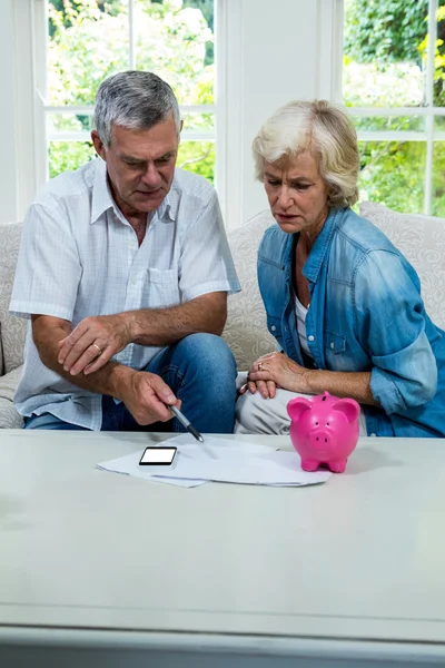 Senior couple calculating savings