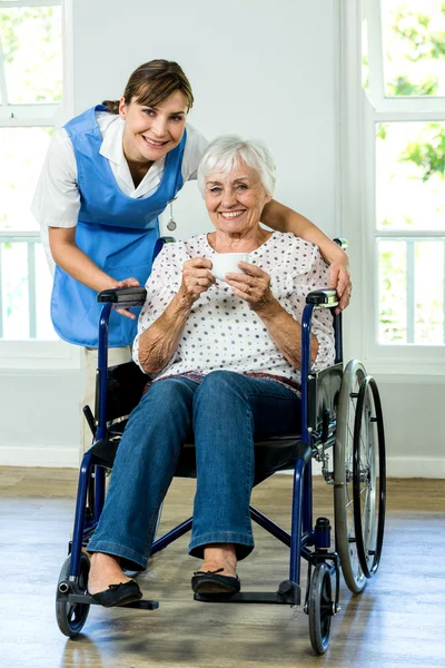 Happy senior woman with nurse