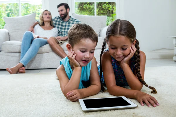 Children watching digital tablet screen