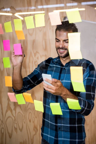 Man writing on sticky notes