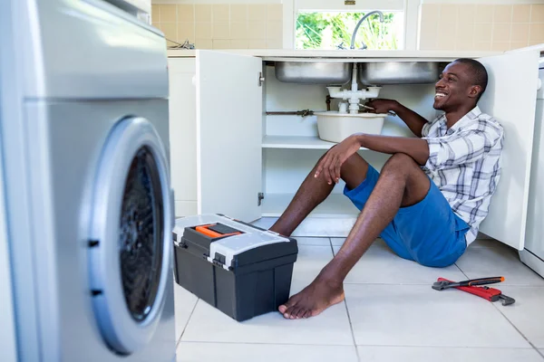 Man repairing kitchen sink